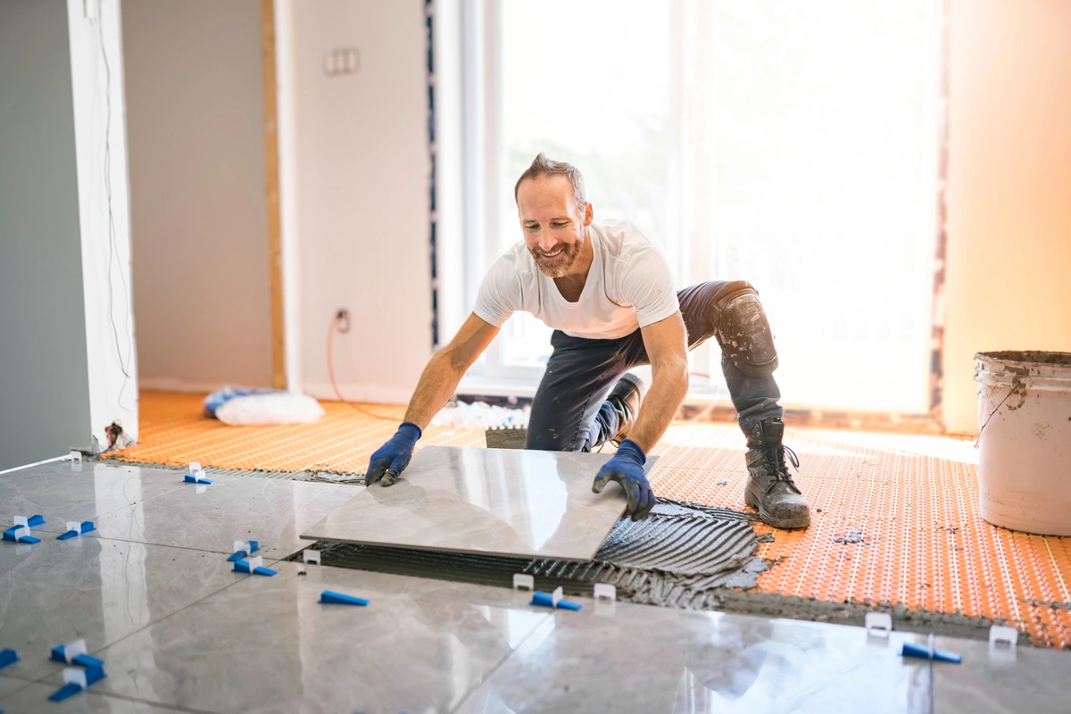 contractor installs marble floor tiles